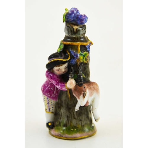 975 - A Meissen porcelain scent bottle, circa 1900, modelled as a boy and goat around a tree stump, the li... 