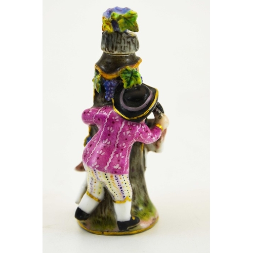 975 - A Meissen porcelain scent bottle, circa 1900, modelled as a boy and goat around a tree stump, the li... 