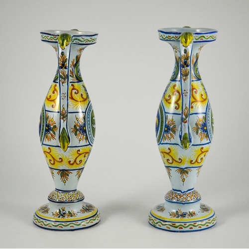 982 - Pair of French faience twin handled vases, circa 1900, decorated with fleur-de-lis in a roundel with... 