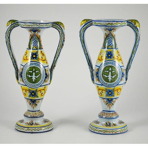 982 - Pair of French faience twin handled vases, circa 1900, decorated with fleur-de-lis in a roundel with... 