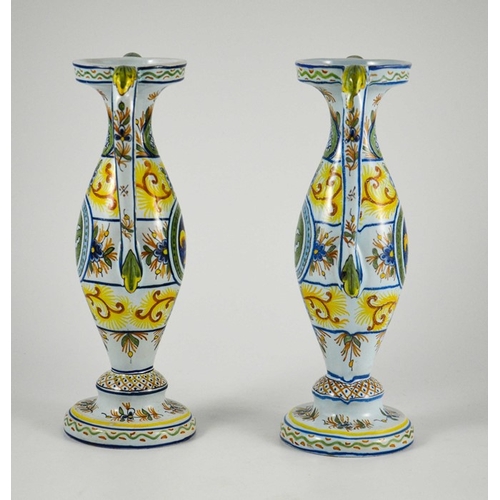 982 - Pair of French faience twin handled vases, circa 1900, decorated with fleur-de-lis in a roundel with... 