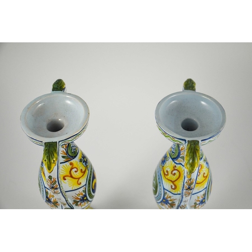 982 - Pair of French faience twin handled vases, circa 1900, decorated with fleur-de-lis in a roundel with... 