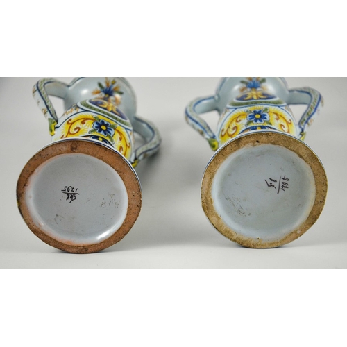 982 - Pair of French faience twin handled vases, circa 1900, decorated with fleur-de-lis in a roundel with... 