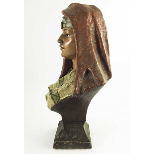 1001 - An Austrian painted plaster bust figure of an Arab woman, circa 1890, modelled in scarf, on plinth b... 