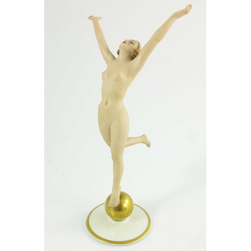 1026 - Hutschenreuther, a Sunchild figure, modelled as a nude woman on a gilt sphere, 22cm high