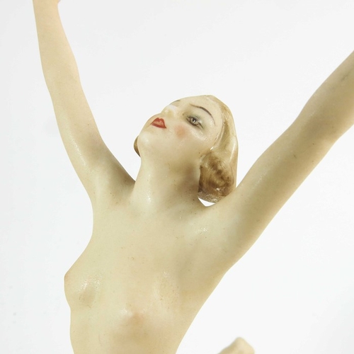 1026 - Hutschenreuther, a Sunchild figure, modelled as a nude woman on a gilt sphere, 22cm high