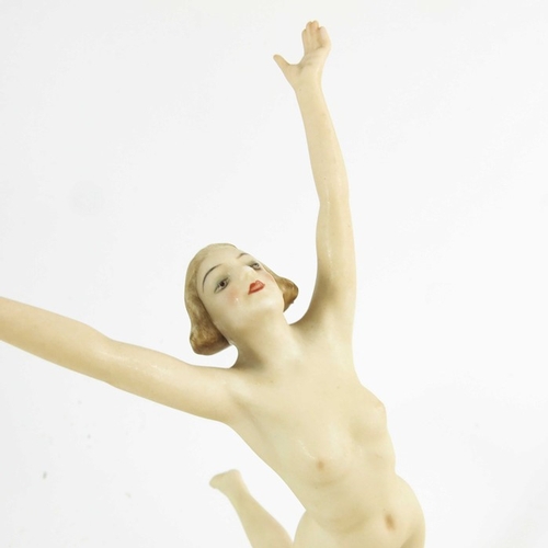 1026 - Hutschenreuther, a Sunchild figure, modelled as a nude woman on a gilt sphere, 22cm high