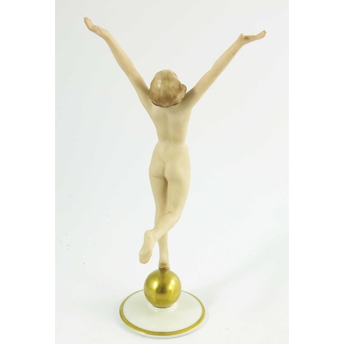 1026 - Hutschenreuther, a Sunchild figure, modelled as a nude woman on a gilt sphere, 22cm high