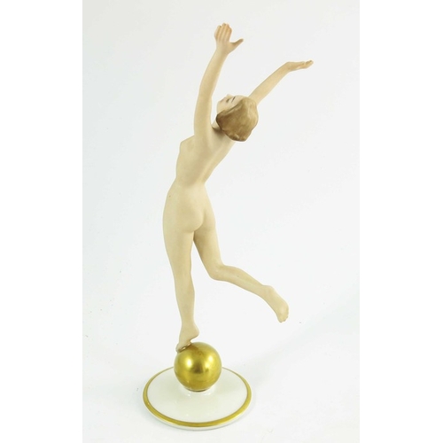 1026 - Hutschenreuther, a Sunchild figure, modelled as a nude woman on a gilt sphere, 22cm high