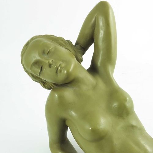 1029 - A Goldscheider figure Traumende, circa 1942, modeled as a reclining nude with an imitation patinated... 