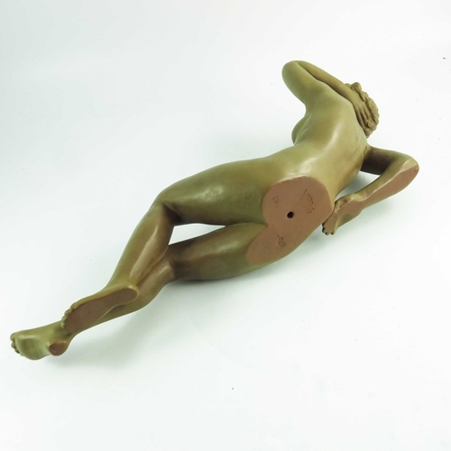 1029 - A Goldscheider figure Traumende, circa 1942, modeled as a reclining nude with an imitation patinated... 