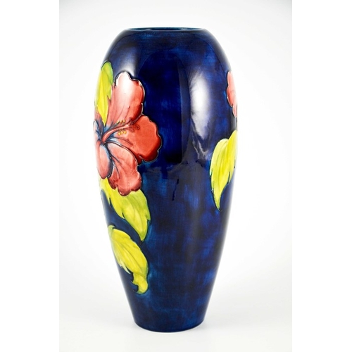 1080 - Walter Moorcroft, a large Hibiscus vase, circa 1960s, elongated ovoid form, red and yellow on blue, ... 