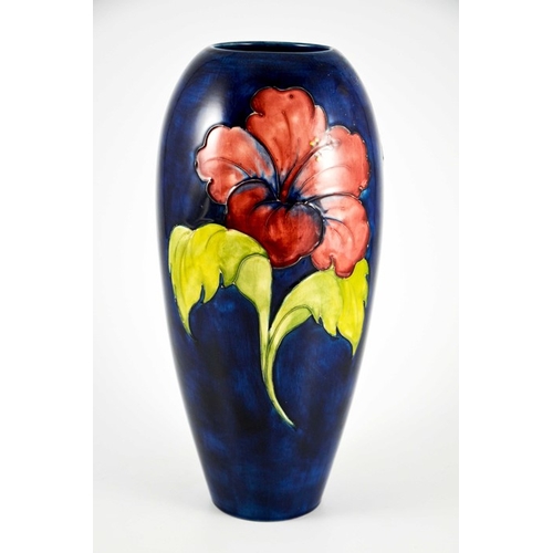 1080 - Walter Moorcroft, a large Hibiscus vase, circa 1960s, elongated ovoid form, red and yellow on blue, ... 