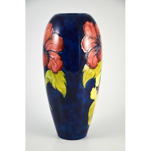 1080 - Walter Moorcroft, a large Hibiscus vase, circa 1960s, elongated ovoid form, red and yellow on blue, ... 