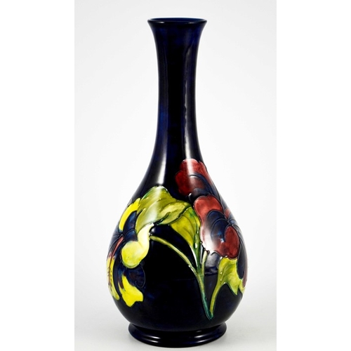 1087 - Walter Moorcroft, a Hibiscus vase, circa 1960s, elongated neck baluster form, on blue, impressed mar... 