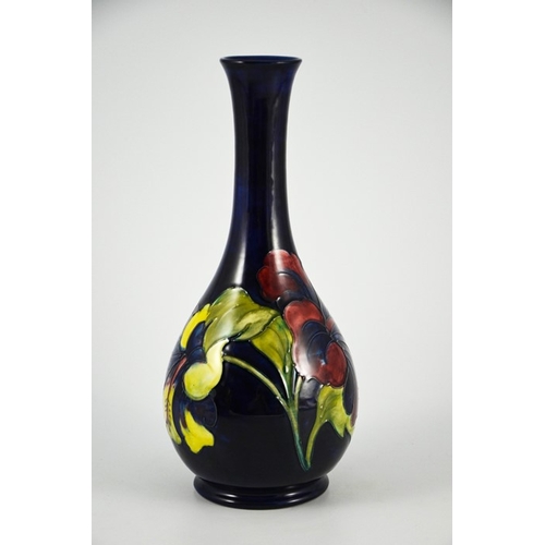 1087 - Walter Moorcroft, a Hibiscus vase, circa 1960s, elongated neck baluster form, on blue, impressed mar... 