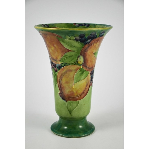 1121 - William Moorcroft for James MacIntyre, a Pomegranate on green vase, circa 1910, footed trumpet form,... 