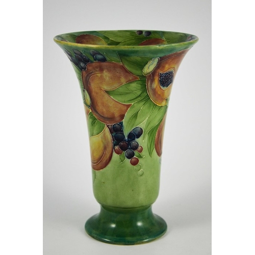 1121 - William Moorcroft for James MacIntyre, a Pomegranate on green vase, circa 1910, footed trumpet form,... 