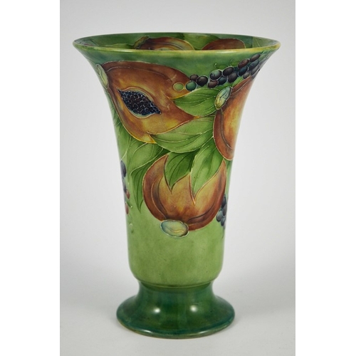 1121 - William Moorcroft for James MacIntyre, a Pomegranate on green vase, circa 1910, footed trumpet form,... 