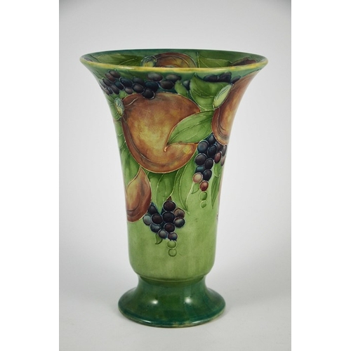 1121 - William Moorcroft for James MacIntyre, a Pomegranate on green vase, circa 1910, footed trumpet form,... 