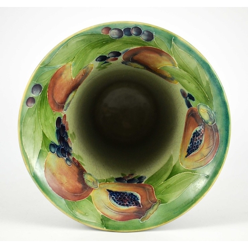 1121 - William Moorcroft for James MacIntyre, a Pomegranate on green vase, circa 1910, footed trumpet form,... 