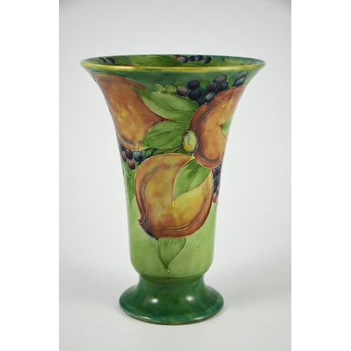 1121 - William Moorcroft for James MacIntyre, a Pomegranate on green vase, circa 1910, footed trumpet form,... 