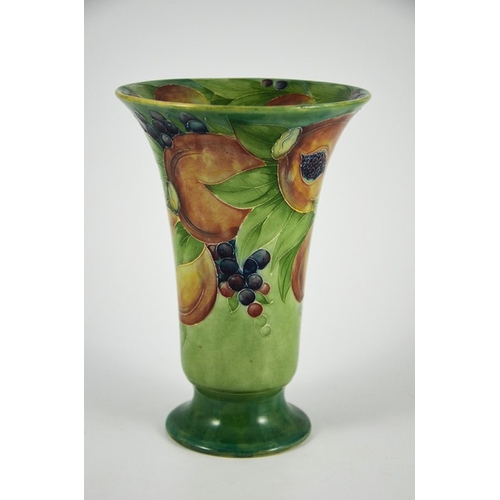 1121 - William Moorcroft for James MacIntyre, a Pomegranate on green vase, circa 1910, footed trumpet form,... 