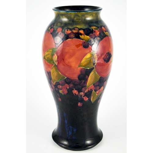 1123 - William Moorcroft, a large Pomegranate on ochre and blue vase, circa 1918, elongated inverse baluste... 