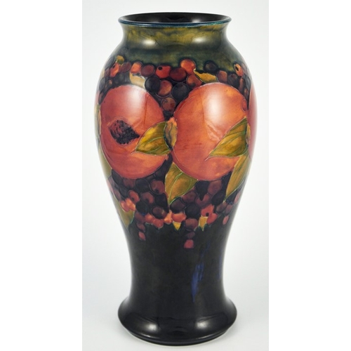 1123 - William Moorcroft, a large Pomegranate on ochre and blue vase, circa 1918, elongated inverse baluste... 