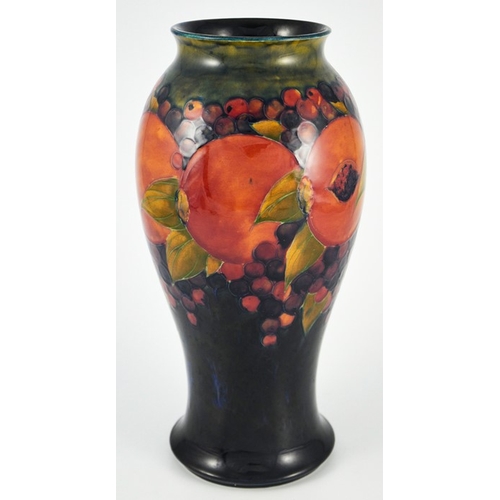 1123 - William Moorcroft, a large Pomegranate on ochre and blue vase, circa 1918, elongated inverse baluste... 