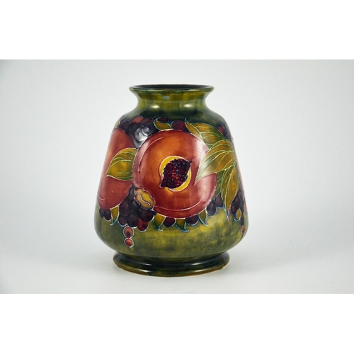 1124 - William Moorcroft, a Pomegranate on ochre vase, circa 1916, conical ovoid form, impressed Burslem ma... 