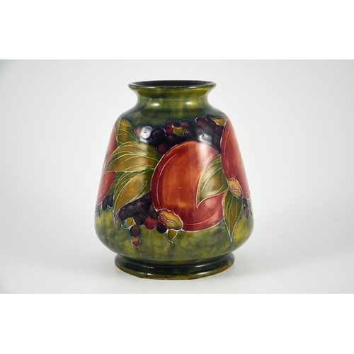 1124 - William Moorcroft, a Pomegranate on ochre vase, circa 1916, conical ovoid form, impressed Burslem ma... 