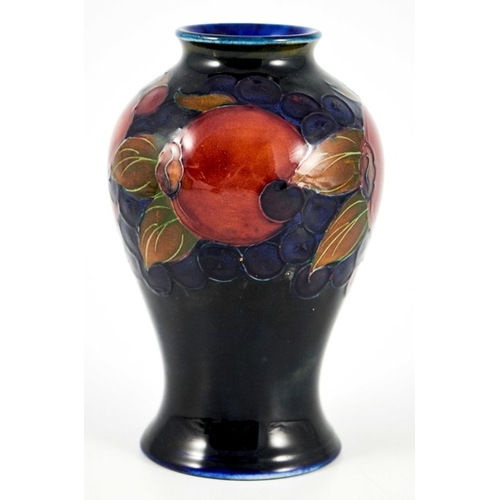 1125 - William Moorcroft, a Pomegranate on blue vase, circa 1928, inverse baluster form, impressed marks an... 