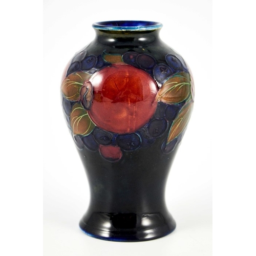 1125 - William Moorcroft, a Pomegranate on blue vase, circa 1928, inverse baluster form, impressed marks an... 