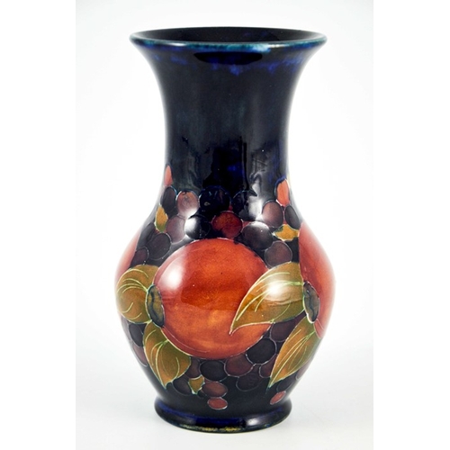 1130 - William Moorcroft, a Pomegranate on blue vase, circa 1915, flared neck baluster form, impressed Burs... 