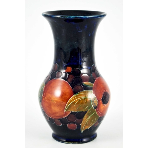 1130 - William Moorcroft, a Pomegranate on blue vase, circa 1915, flared neck baluster form, impressed Burs... 