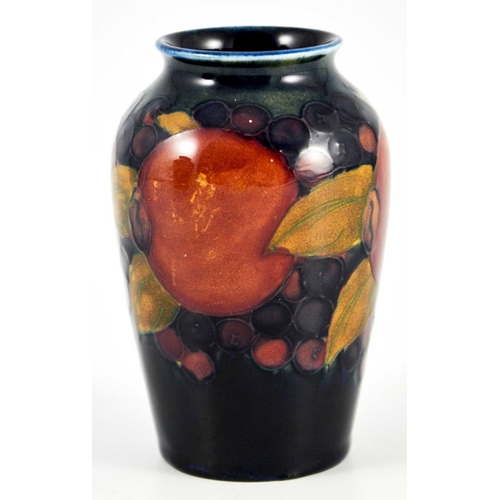 1131 - William Moorcroft, a small Pomegranate on blue vase, circa 1928, shouldered form, impressed mark and... 