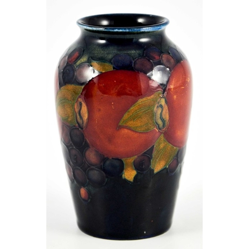 1131 - William Moorcroft, a small Pomegranate on blue vase, circa 1928, shouldered form, impressed mark and... 