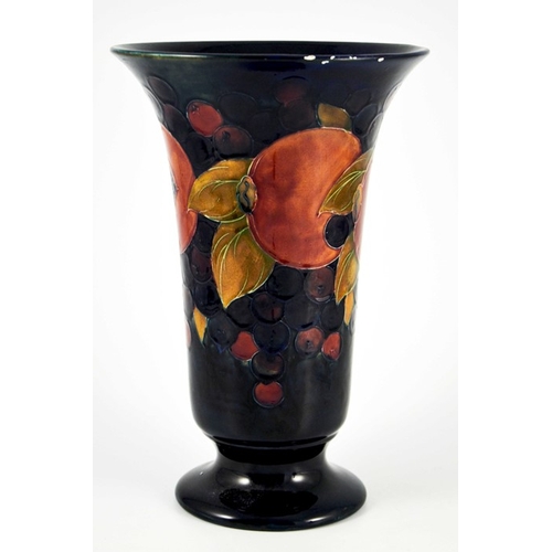 1132 - William Moorcroft, a large Pomegranate on blue vase, circa 1928, footed trumpet form, impressed mark... 