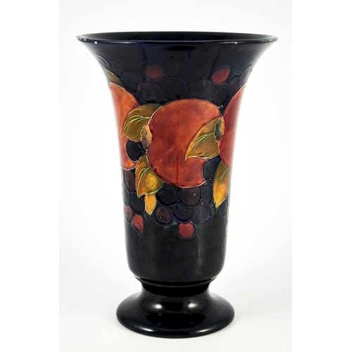 1132 - William Moorcroft, a large Pomegranate on blue vase, circa 1928, footed trumpet form, impressed mark... 