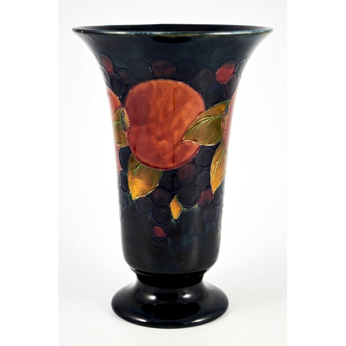 1132 - William Moorcroft, a large Pomegranate on blue vase, circa 1928, footed trumpet form, impressed mark... 