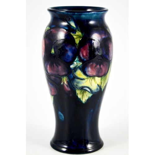 1135 - William Moorcroft, a Pansy on blue vase, circa 1925, elongated inverse baluster form, impressed mark... 