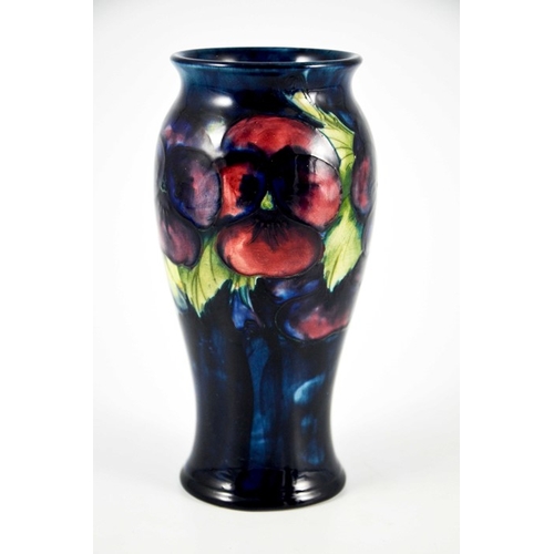 1135 - William Moorcroft, a Pansy on blue vase, circa 1925, elongated inverse baluster form, impressed mark... 