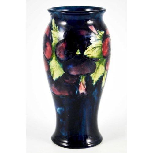 1135 - William Moorcroft, a Pansy on blue vase, circa 1925, elongated inverse baluster form, impressed mark... 