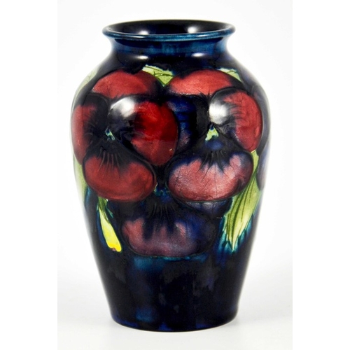 1136 - William Moorcroft, a small Pansy on blue vase, circa 1925, impressed marks, underglaze blue monogram... 