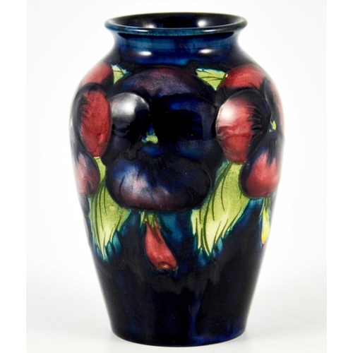 1136 - William Moorcroft, a small Pansy on blue vase, circa 1925, impressed marks, underglaze blue monogram... 