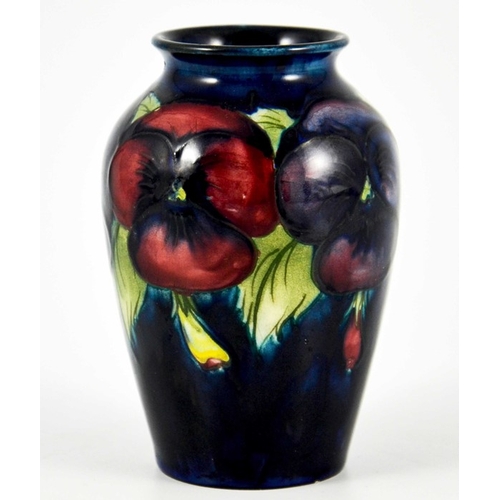 1136 - William Moorcroft, a small Pansy on blue vase, circa 1925, impressed marks, underglaze blue monogram... 