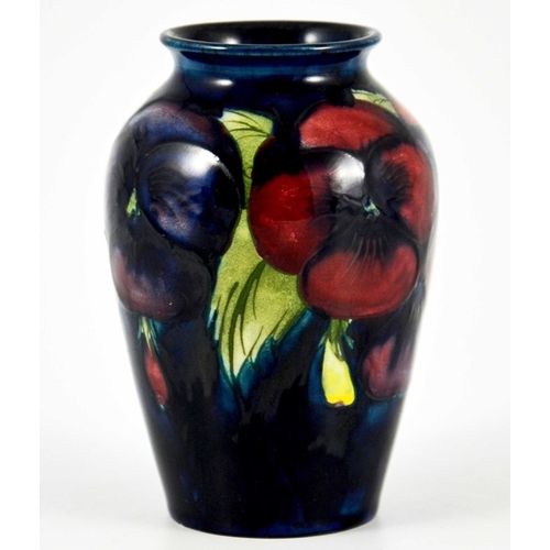 1136 - William Moorcroft, a small Pansy on blue vase, circa 1925, impressed marks, underglaze blue monogram... 