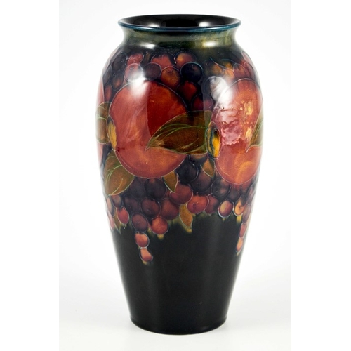 1139 - William Moorcroft, a Pomegranate on ochre and blue vase, circa 1915, ovoid form with everted rim, im... 