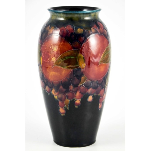 1139 - William Moorcroft, a Pomegranate on ochre and blue vase, circa 1915, ovoid form with everted rim, im... 